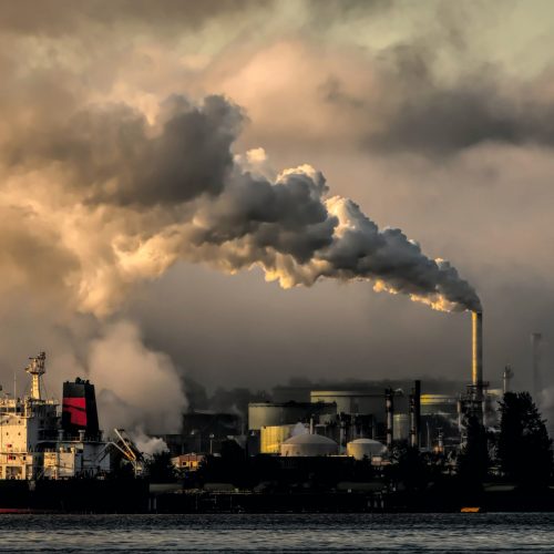 smoke stacks and ships emitting gases